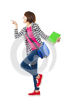 Happy student holding books and showing something