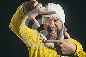 Happy student makes funny picture for his blog. Amazed man taking a selfie. Black Friday.