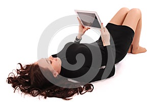 Happy student teenage girl lying on the floor with tablet pc
