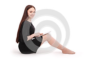 Happy student teenage girl sitting on the floor with tablet pc