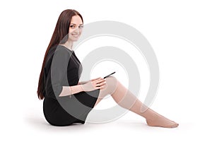 Happy student teenage girl sitting on the floor with tablet pc