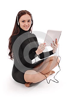 Happy student teenage girl sitting on the floor with tablet pc