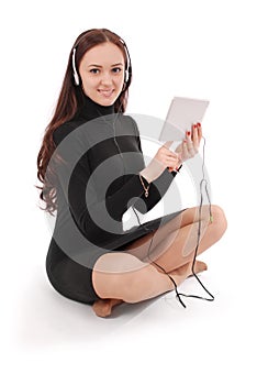 Happy student teenage girl sitting on the floor with tablet pc