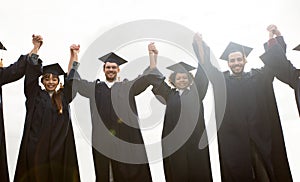 Happy students or bachelors celebrating graduation