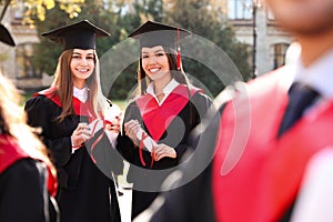 Happy students with diplomas. Graduation ceremony