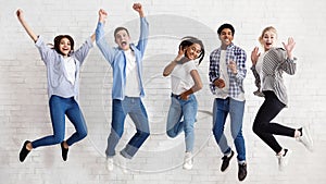 Happy students jumping on white background, passed exams