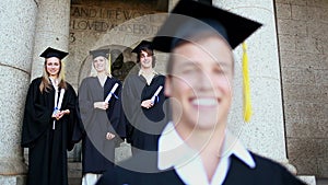 Happy students standing behind a friend