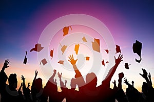 students throwing graduation caps in the Air