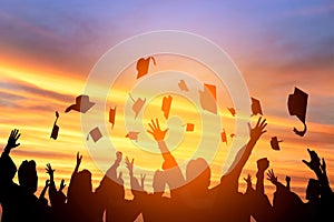 students throwing graduation caps in the Air photo