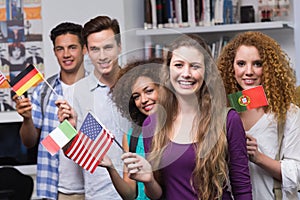 Happy students waving international flags