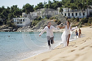 Happy stylish couple just married, have escape in Greece in perfect sunny summer day.