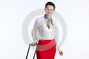 happy stylish female air hostess on white