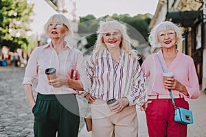 Happy stylish grandmothers are walking in the city