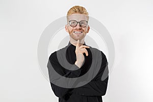 Happy Stylish guy in black shirt and glasses. Folded arms, copy space. Successful young, Entrepreneur concept. Redheaded man