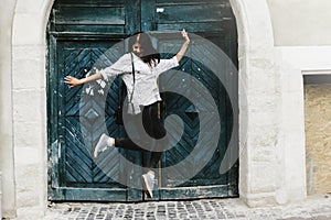 Happy stylish hipster woman jumping and having fun