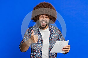 Happy stylish man open envelope take out letter reads, bank loan approve, great news, award, win