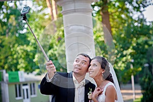 Happy stylish smiling couple walking and make selfy