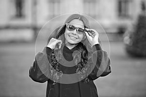 happy stylish teen girl outside. stylish teen girl wear glasses. photo of stylish teen girl