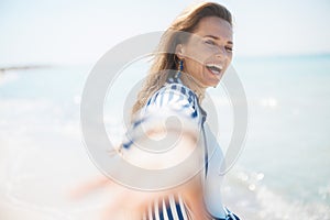 happy stylish woman on ocean coast having fun time
