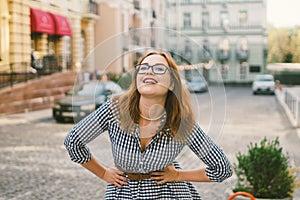 Happy stylish woman at old european city street, moment of carefree and true happiness. Young beautiful cheerful woman