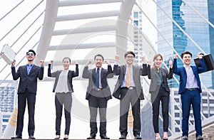 Happy Successful business group People Hands Raised successful with city background Successful business group with arms up