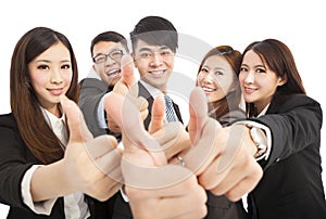 Happy successful business team with thumbs up