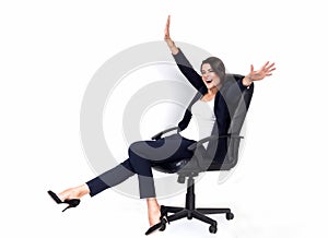 Happy successful business woman in office chair