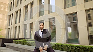 Happy Successful Businessman Dancing on the background of a modern building