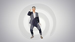Happy Successful Businessman Dancing In a Crazy Way on gradient background.
