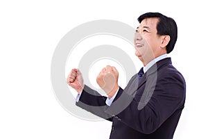 Happy, successful businessman looking up at blank space