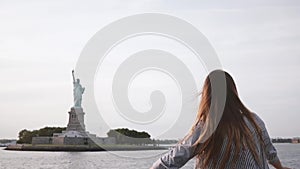 Happy successful businesswoman with hair blowing in the wind enjoying epic Statue of Liberty view on a boat slow motion.