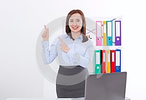 Happy and successful businesswoman raising her arms at office background and showing something isolated on white. mock up