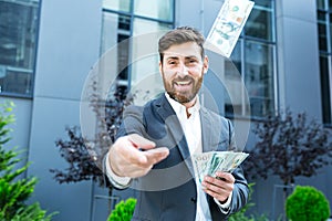 Happy successful Caucasian bearded businessman counts, waves, throws, show off, flaunt cash money background a modern office