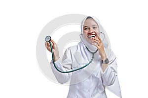 Happy successful female Asian Muslim nurse or doctor, smiling confidently with holding a stethoscope