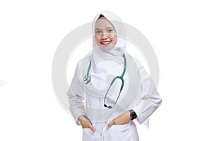 Happy successful female Asian Muslim nurse or doctor, smiling with hand in the bag