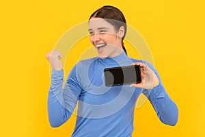 happy successful girl with cellphone showing screen copy space, success