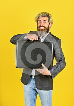 Happy and successful man hold money case. bearded man show office briefcase. good business deal. successful business