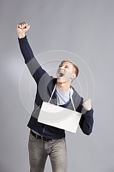 Happy successful man presenting empty signboard.