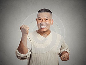 Happy successful student, man winning fists pumped celebrating success