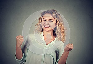 Happy successful woman pumping fists celebrating success