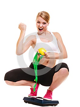 Happy successful woman weighing scale. Weight loss