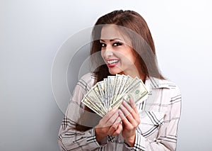 Happy successful yound woman holding dollars in hands with tooth