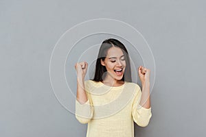 Happy successful young woman shouting and celebrating success