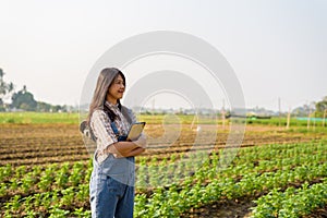Happy successfull woman smart farmer holding tablet at her farm for modern farming, smart woman, technology, online market idea