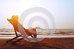 Happy summer beach holidays, woman relaxing in deckchair, tropical vacation