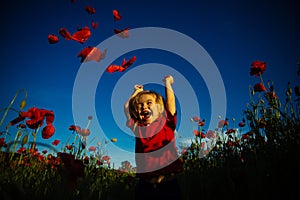 Happy summer. Child in poppy field. Kid with red flowers nature. Happy walk.