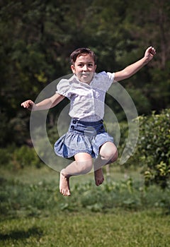 Happy summer girl teenager jumping outdoor.