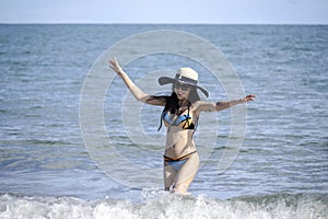 Happy summer holiday vacation, hot sexy beautiful woman in bikini and hat walking, resting and spending time to relexation on