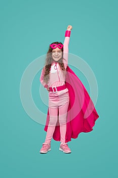 Happy superhero kid girl with fist up