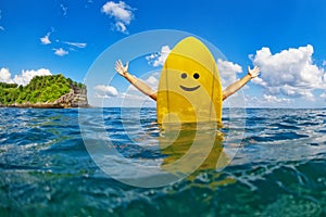 Happy surfer girl sit on yellow surfboard with smiley face